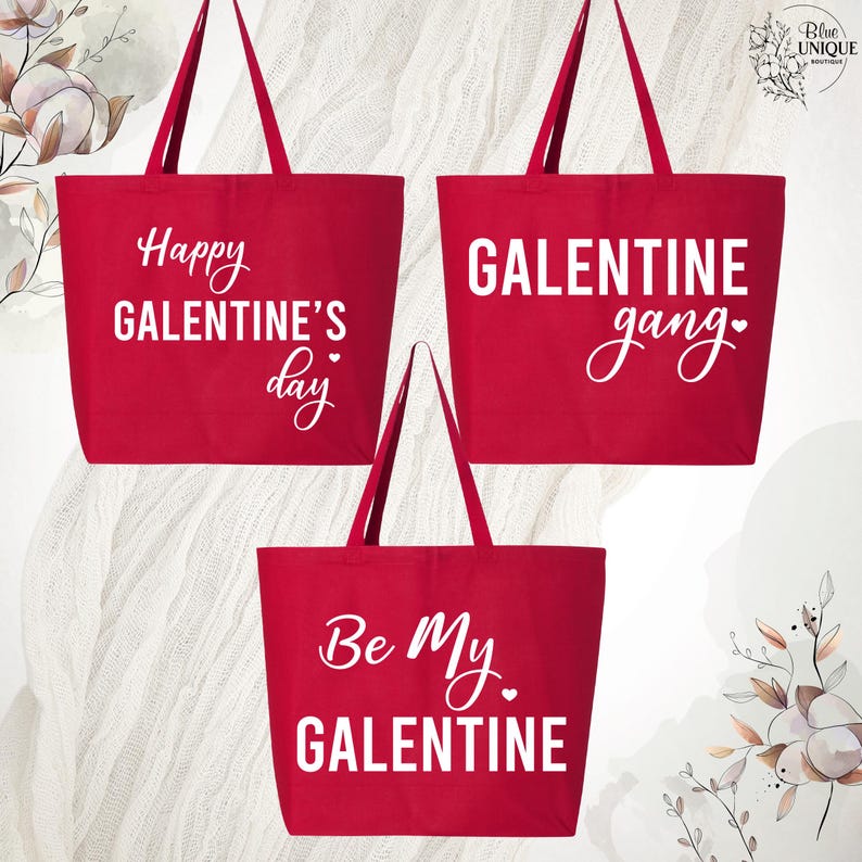 May include: Three red tote bags with white text. The top left bag says "Happy Galentine's Day", the top right bag says "GALENTINE gang", and the bottom bag says "Be My GALENTINE". The bags have long handles.