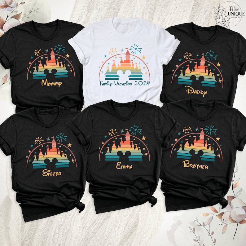 May include: Set of six black t-shirts with a retro rainbow design of the Disney castle and fireworks. Each shirt has a different name printed on it: Mommy, Family Vacation 2024, Daddy, Sister, Emma, and Brother.