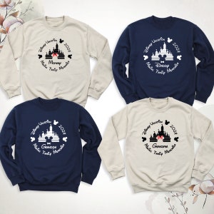 May include: Four cream and navy blue sweatshirts with a black and white graphic of Cinderella's castle with Mickey Mouse ears on top. The text on the sweatshirts reads "Disney Vacation 2024" and "Making Family Memories" with the words "Momma", "Daddy", "Grandpa", and "Grandma" underneath the castle.
