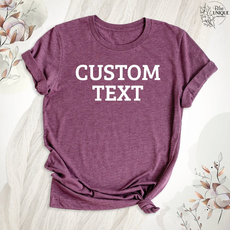May include: A maroon t-shirt with the text "CUSTOM TEXT" printed in white on the front.