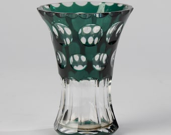 May include: A clear glass vase with a green, cut-glass design. The vase has a wide mouth and a narrow base.