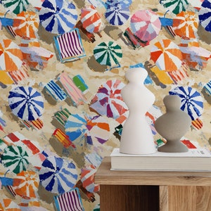 May include: A colourful abstract painting of beach umbrellas and beach towels on a sandy beach. The painting is done in a loose, gestural style with bright colours and bold strokes.