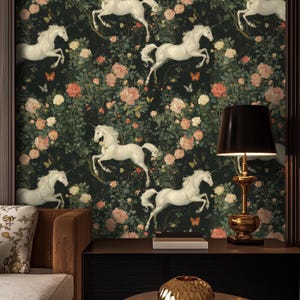 May include: A dark green wallpaper with a repeating pattern of white unicorns and pink flowers. The wallpaper is shown in a room with a brown leather couch and a black lamp with a black lampshade.