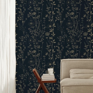 May include: Dark navy wallpaper with a repeating pattern of stylized beige wildflowers and foliage. A wooden side table holds books and a glass of water. A beige sofa and white curtain are also visible.