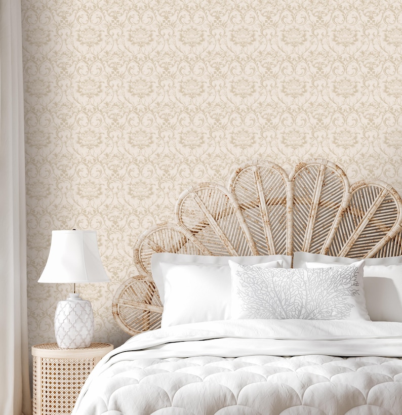 May include: A white bed with a white comforter and two white pillows. The headboard is a large, woven, fan-shaped headboard. The wall behind the bed is covered in a beige wallpaper with a subtle damask pattern.