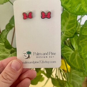 May include: A pair of pink bow earrings on a white card with the text "Palm and Pine DESIGN 321 palmandpine321.etsy.com"