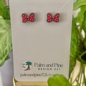 May include: A pair of red and white polka dot bow earrings on a white card with the text "Palm and Pine DESIGN 321 palmandpine321.etsy.com".