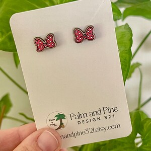 May include: A pair of red and white polka dot bow earrings on a white card with the text "Palm and Pine DESIGN 321 handpine321.etsy.com".