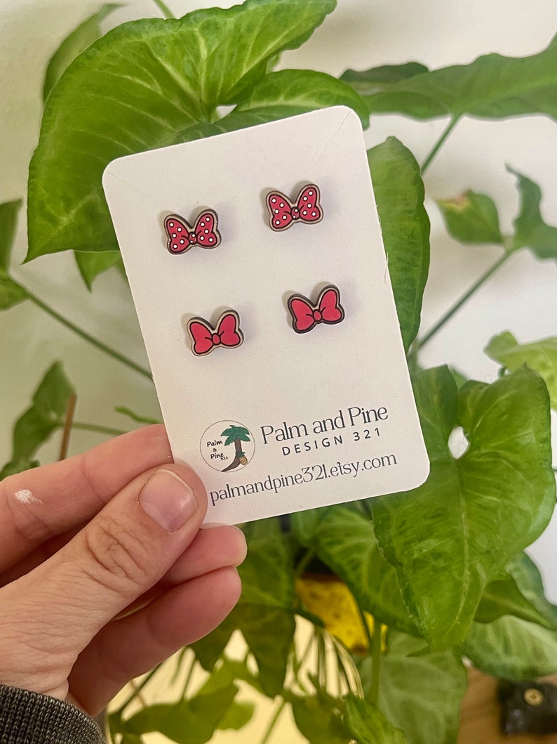 May include: Four red and white polka dot bow earrings on a white card with the text "Palm and Pine DESIGN 321 palmandpine321.etsy.com".