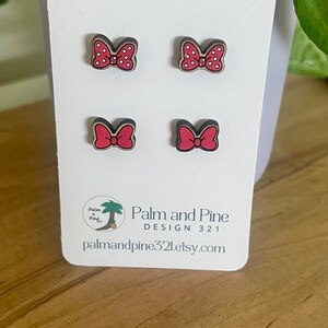 May include: Four red and white polka dot bow earrings on a white card with the text "Palm and Pine Design 321 palmandpine321.etsy.com"