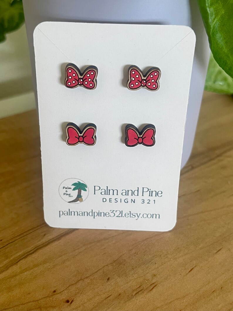 May include: Four red and white polka dot bow earrings on a white card with the text "Palm and Pine Design 321 palmandpine321.etsy.com"