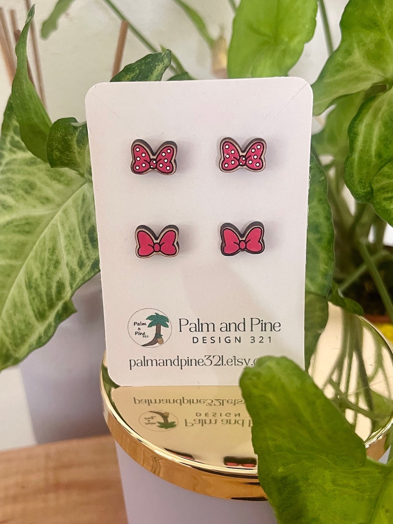 May include: A set of four pink and white polka dot bow earrings on a white card with the text "Palm and Pine Design 321 palm and pine321.etsy.com".