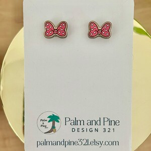May include: A pair of pink and white polka dot bow earrings on a white card with the text "Palm and Pine DESIGN 321 palmandpine321.etsy.com".