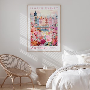 a bedroom with a bed, a wicker chair, and a framed poster of a cityscape with a flower market in the background.