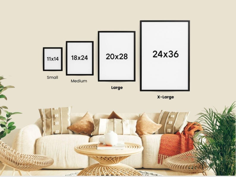 a living room with a white sofa and a coffee table. Above the sofa, there are four framed pictures of different sizes, ranging from 11x14 to 24x36, indicating the dimensions of each picture. The room also has a potted plant and a rug, adding to the cozy and inviting atmosphere.