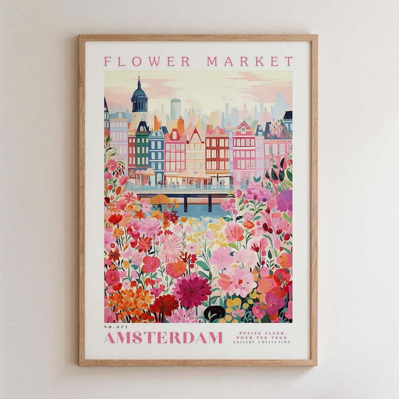 May include: A framed art print featuring a colorful illustration of Amsterdam's Flower Market. The artwork showcases vibrant flowers in the foreground, with buildings and a canal in the background. The print includes the text "FLOWER MARKET" and "AMSTERDAM".