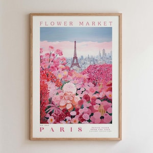 May include: A framed art print titled "Flower Market" featuring a vibrant illustration of the Eiffel Tower in Paris, surrounded by pink and red flowers. The artwork has the word "Paris" at the bottom.