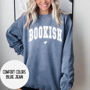 May include: A blue jean sweatshirt with the word "BOOKISH" in white lettering and a small white heart below it.