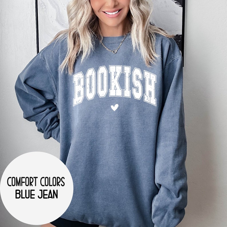 May include: A blue jean sweatshirt with the word "BOOKISH" in white lettering and a small white heart below it.