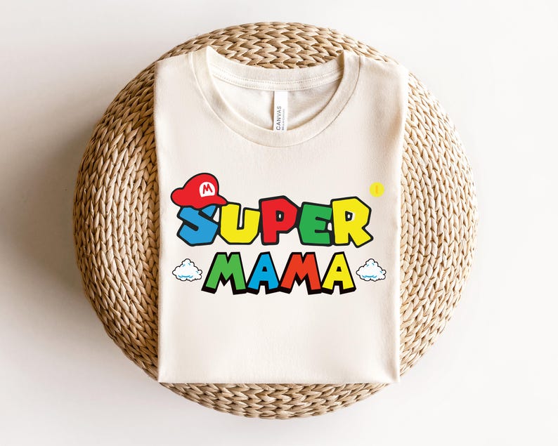 May include: A white t-shirt with a colorful graphic of a Super Mario character wearing a hat and the text "Super Mama".