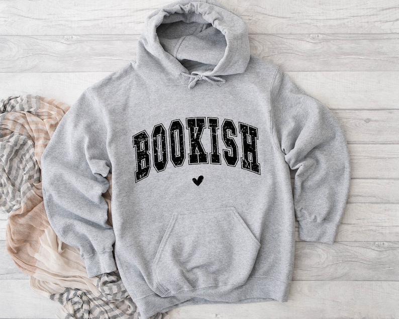 May include: Gray hooded sweatshirt with the word "BOOKISH" in black block letters with a small black heart below the word.