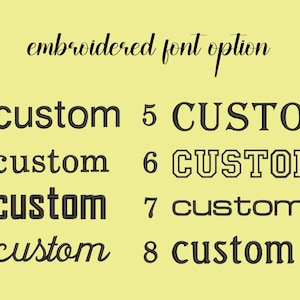May include: Eight different embroidered font options for customizing a product. The options are numbered 1 through 8. The fonts range from simple to more decorative.
