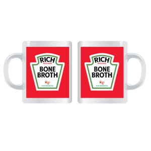 May include: Two white ceramic mugs with a red background and a green and white label that reads "RICH NUTRITIONAL BONE BROTH NOURISHING". The mugs have a white handle.