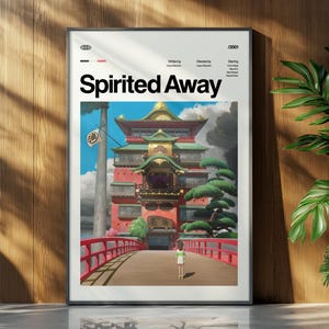 Może przedstawiać: Oprawiony plakat z tytułem "Spirited Away" w białych literach. Grafika przedstawia czerwony most prowadzący do wielopoziomowego budynku, z postacią idącą w jego kierunku. Plakat jest w czarnej ramie.