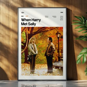 May include: A framed movie poster for "When Harry Met Sally" with a photo of the two main characters in a park setting. The poster has a white border and is displayed against a wooden wall with a plant.
