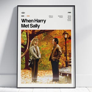 May include: A framed movie poster for "When Harry Met Sally" with a black frame. The poster features a photo of the two main characters in a park setting with fall foliage. The title and credits are at the top.