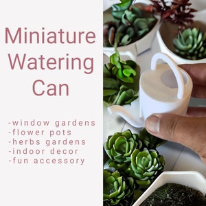 May include: A white miniature watering can with a curved handle and spout, held by a hand. The image includes text that reads "Miniature Watering Can" and lists "window gardens, flower pots, herbs gardens, indoor decor, fun accessory."