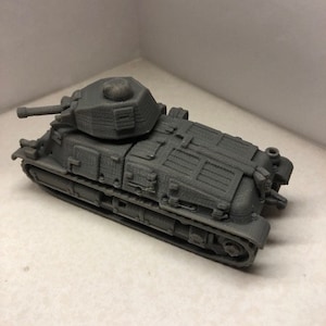 May include: A gray 3D printed model of a tank with a turret and tracks.