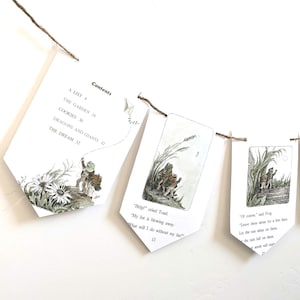 May include: A whimsical banner featuring pages from a children's book, strung together with twine. The pages display illustrations of a frog and toad, with text excerpts like "Help!" and "Of course." The banner includes the book's contents.