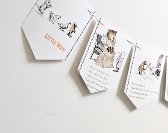 May include: A banner with illustrations from a children's book, featuring a bear and other animals. The banner has the words "LITTLE BEAR" printed on it. The illustrations are in black and white with a vintage style.
