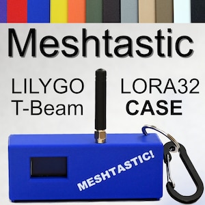 May include: A blue case with a black antenna, a small screen, and a carabiner clip. The case has the text "MeshTastic!" printed on it. The text "LILYGO T-Beam LORA32 CASE" is printed above the case.
