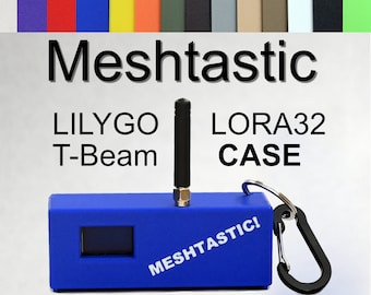 May include: A blue case with a black antenna, a small screen, and a carabiner clip. The case has the text "MeshTastic!" printed on it. The text "LILYGO T-Beam LORA32 CASE" is printed above the case.
