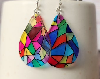 May include: A pair of colorful, stained-glass style teardrop earrings. The earrings feature a mosaic of vibrant colors including red, pink, yellow, green, and blue. They hang from silver-colored fish hook ear wires.