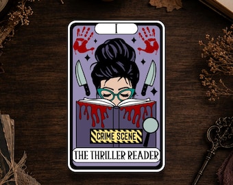 May include: A rectangular sticker featuring a purple tarot card design with a person in a bun hairstyle and teal glasses reading a book with red blood-like drips. It includes two knives, red handprints, a magnifying glass, and the text CRIME SCENE.