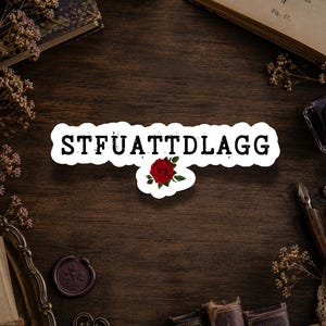 Dark romance bookish sticker featuring the phrase STFUATTDLAGG with a bold design, glitter finish, and waterproof vinyl, made for spicy romance and smut readers.