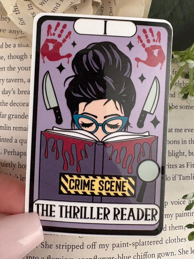 May include: A rectangular sticker featuring a tarot card design with a purple background. It shows a person with a dark bun and teal glasses reading a book with red liquid dripping from it. Two knives, two red handprints, and a magnifying glass are visible.