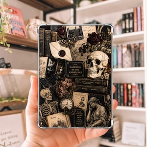 Puede incluir: Una funda rectangular para tableta con un collage oscuro de inspiración gótica. El diseño incluye un cráneo humano, un esqueleto, una estatua clásica, libros antiguos, un reloj de bolsillo, polillas y flores secas. Texto: In the DARKNESS, WE SEEK KNOWLEDGE.