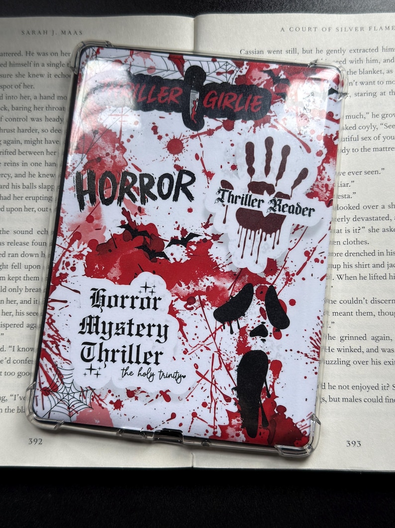 May include: A clear phone case with a horror theme. The case features a white background with red splatter designs and black bat silhouettes. Text includes "HORROR", "Thriller Reader", and "Horror Mystery Thriller".