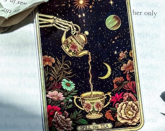 May include: A tarot card illustration featuring a skeleton hand pouring tea from a floral teapot into a teacup. The card has a starry night sky background with flowers and the text "SPILL THE TEA".