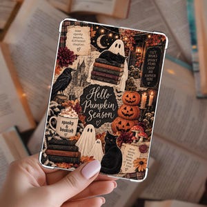 May include: A rectangular e-reader case featuring a collage of autumn and Halloween imagery, including black cats, ghosts, pumpkins, a raven, and stacks of books. The text reads Hello Pumpkin Season, Spooky & bookish, and other phrases.