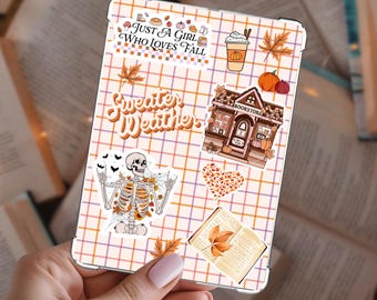 May include: A phone case with a fall theme, featuring the text "Just a Girl Who Loves Fall" and "Sweater Weather." The case has a grid pattern with autumn-themed stickers, including a pumpkin spice latte, pumpkins, and a skeleton.