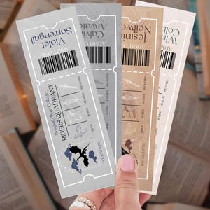 May include: A hand holds four decorative tickets with a fantasy theme. Each ticket features a unique color and design, including text like "RIDERS QUADRANT" and "FOURTH WING". The tickets have a vintage aesthetic.