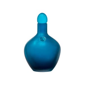 May include: A blue glass bottle with a rounded body and a matching stopper. The bottle has a matte finish and a small, round sticker. The bottle's color transitions from a lighter blue at the top to a darker blue at the base.