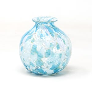 Spherical shaped vase in light blue Murano glass decorated with silver leaf. Made in Italy product by Muma