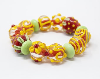 Handmade bracelet with Murano Glass beads with colorful artistic decorations with strawberries and flowers, Made in Italy jewel