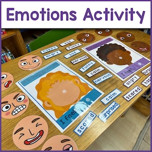 May include: A wooden table with various colorful cards and face cutouts depicting different emotions. The cards have words like "happy", "sad", "angry", "nervous", "calm", "funny", "scared", "surprised", and "angry". The face cutouts have different expressions, such as smiling, frowning, and surprised. The cards and cutouts are used for an emotions activity.